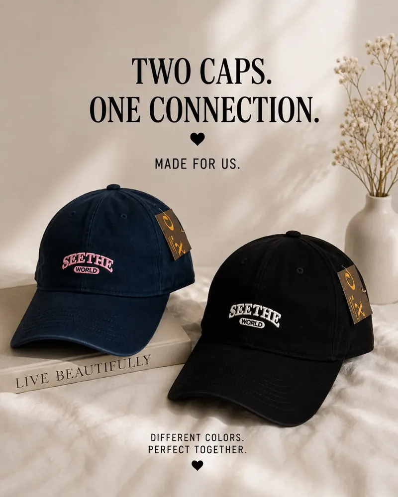 Navy and black Seethe World dad caps on a bed