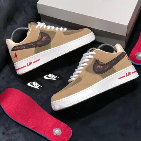Tan sneakers with red insoles
